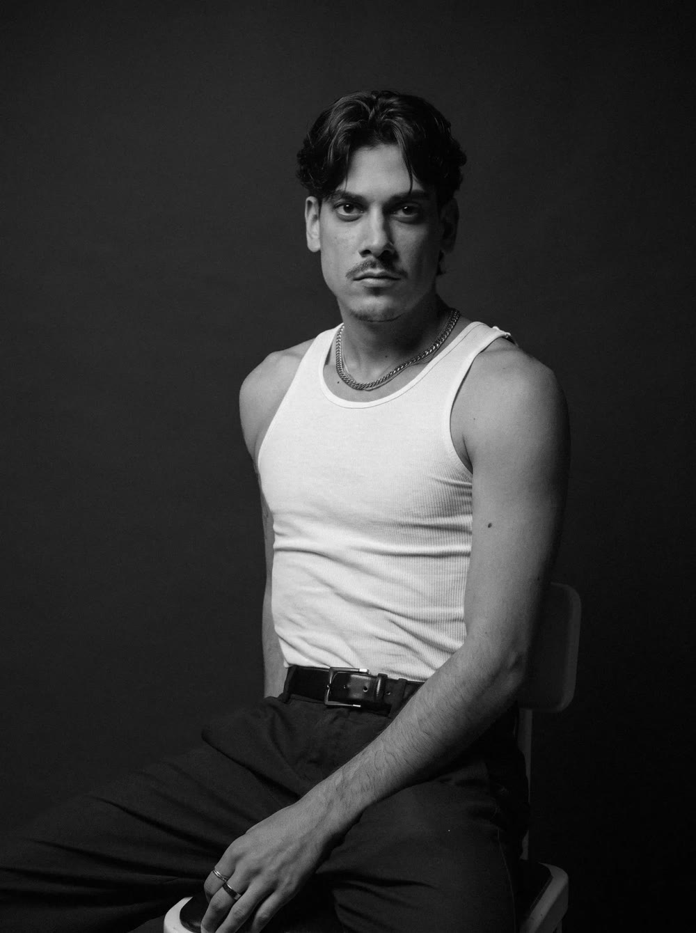 Michelangelo Corrado headshot — white tank, seated
